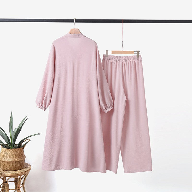 Two -part women's suit made of long shirt and pants with long sleeves and lapels
