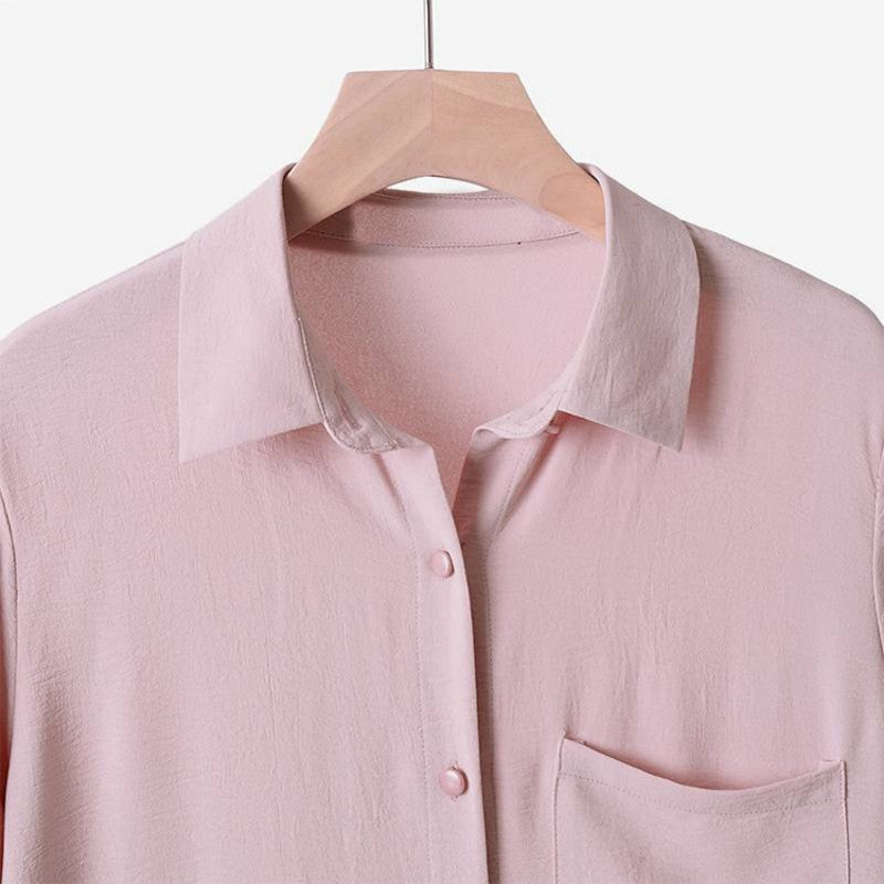 Two -part women's suit made of long shirt and pants with long sleeves and lapels