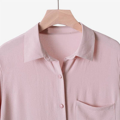 Two -part women's suit made of long shirt and pants with long sleeves and lapels