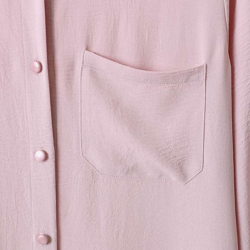 Two -part women's suit made of long shirt and pants with long sleeves and lapels