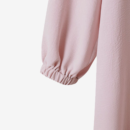 Two -part women's suit made of long shirt and pants with long sleeves and lapels