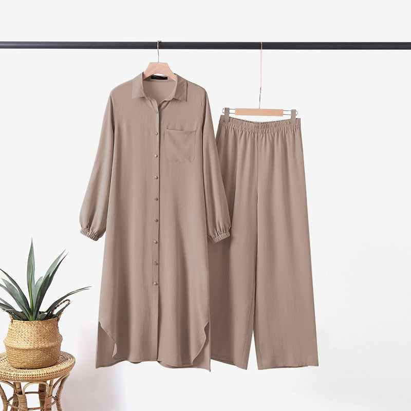 Two -part women's suit made of long shirt and pants with long sleeves and lapels