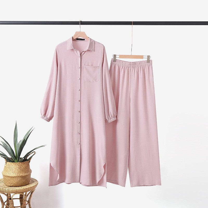 Two -part women's suit made of long shirt and pants with long sleeves and lapels